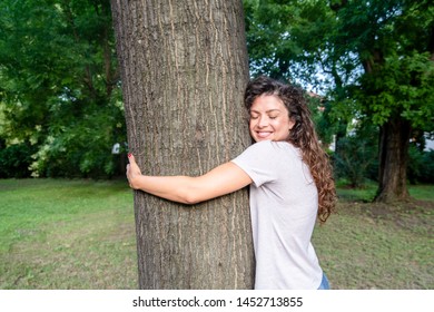 Beautiful Smiling Young Positive And Happy Environmentalist Girl Hugging The Big Tree In The Park Love The Nature And Want To Protect Environment Environmental Concept Save The Forest