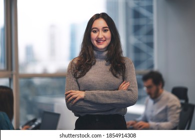 Beautiful Smiling Young Turkish Woman In A Modern Office With Her Colleagues.