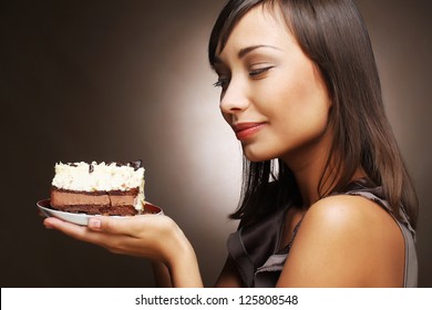 The Beautiful Smiling Young Woman With A Cake