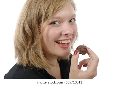 Beautiful Smiling Young Woman Eating A Chocolate Candy