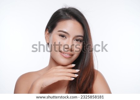 Beautiful smiling young woman with flawless dewy skin smiling at camera