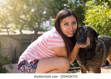 beautiful smiling young woman hugging her dog - Powered by Shutterstock