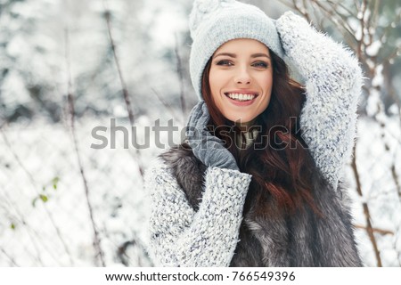 beautiful smiling young woman in wintertime outdoor. Winter concept 
