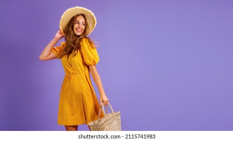 Beautiful smiling young woman in yellow dress, summer straw hat, bag isolated on pastel violet background. People sincere emotions, lifestyle concept. Mock up copy space. - Powered by Shutterstock