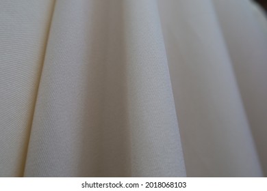 Beautiful And Smooth Bright Clothe Is Hanging In A Low Light Room.