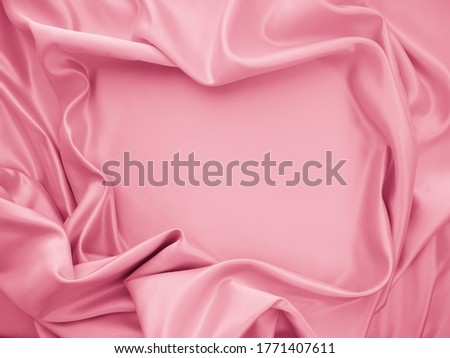 Beautiful smooth elegant wavy hot baby pink satin silk luxury cloth fabric texture, abstract background design. Copy space
