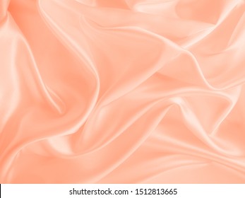 Beautiful smooth elegant wavy light peach orange satin silk luxury cloth fabric texture, abstract background design. Copy space
