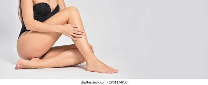 Beautiful and smooth female legs after depilation on a gray background, Stock Photo
