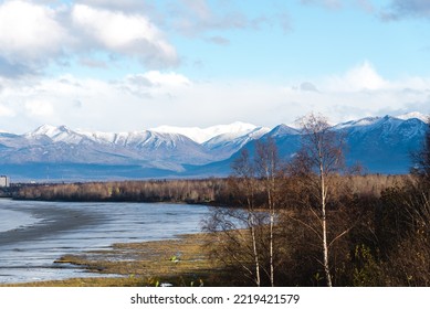 Beautiful Snow Cap Chugach Mountain And Downtown Anchorage From Kincaid Park. Aerial View Coastal Trail Along Cook Inlet, Turnagain Arm  With Buildings Skyscraper