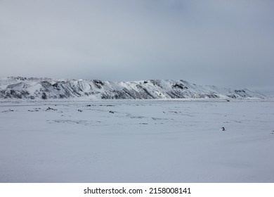 Beautiful snow and ice covered mountain chain in a desolated arctic nordic landscape on the way to Mývatn, northern Iceland, Europe