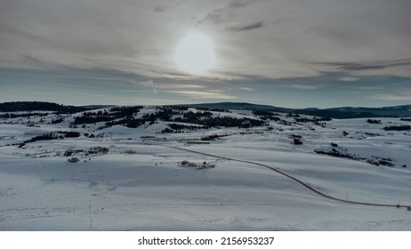 A Beautiful Snowy Field During Sunset