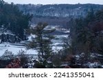 Beautiful snowy winter afternoon scene of the St. Croix River Valley at Interstate State Park during the blue hour in Taylors Fallls, MN. Valley was formed during the Ice Age.