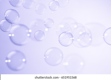 Beautiful soap bubbles on purple background