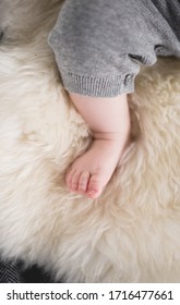 A Beautiful Soft Delicate Warm Young Baby Foot Photographed With A Shallow Depth Of Field. Gentle Calm Colours And Feel. Baby Care And Well Being. Babies Feet On A Cream Fur Rug.