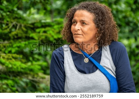 Beautiful South American woman, middle-aged with curly hair, and a lost and sad gaze
