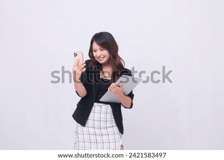 Beautiful Southeast Asian woman 20s formal office elegant smile taking photo in front of camera carrying tablet for promo isolated white background