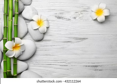 Beautiful spa composition with bamboo on light wooden background