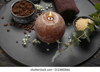 Beautiful spa composition with burning candle on dark wooden background, closeup