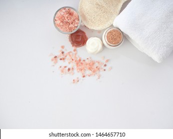 Beautiful Spa Composition With Himalayan Pink Salt, Fragrant Potpourri, Luffa Scrub On A White Background.