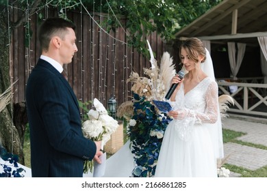 Beautiful Space Wedding Ceremony In The Summer Of A Chic Couple, The Groom In A Suit And The Bride In A White Luxurious Wedding Dress.