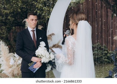 Beautiful Space Wedding Ceremony In The Summer Of A Chic Couple, The Groom In A Suit And The Bride In A White Luxurious Wedding Dress.