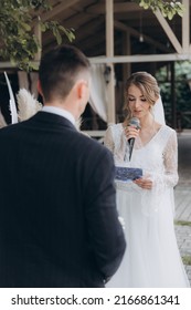 Beautiful Space Wedding Ceremony In The Summer Of A Chic Couple, The Groom In A Suit And The Bride In A White Luxurious Wedding Dress.