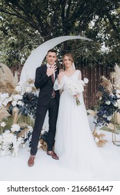 Beautiful Space Wedding Ceremony In The Summer Of A Chic Couple, The Groom In A Suit And The Bride In A White Luxurious Wedding Dress.