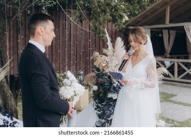 Beautiful Space Wedding Ceremony In The Summer Of A Chic Couple, The Groom In A Suit And The Bride In A White Luxurious Wedding Dress.