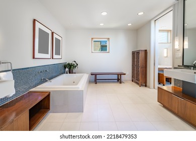 beautiful spacious white and blue bathroom with square freestanding bathtub mosaic tile wall mounted sinks glass shower stall and marble floors - Powered by Shutterstock