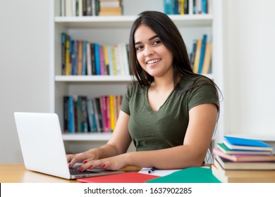 Beautiful spanish female student at computer at university