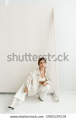 Similar – Woman in work wear in her workshop by table with handmade items