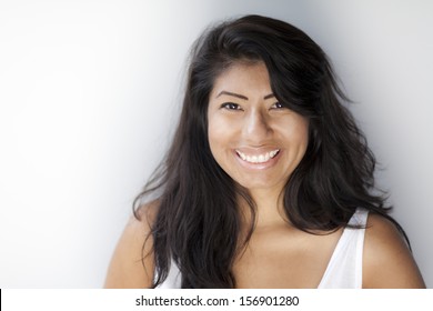 Beautiful Spanish Woman Smiling At The Camera Isolated On White