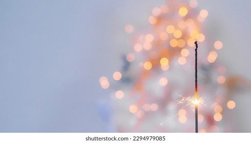 Beautiful sparkles from sparklers on the background of New Year's bokeh, Christmas mood, glitter, festive background. - Powered by Shutterstock