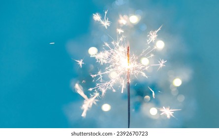 Beautiful sparkles from sparklers on the background of New Year's bokeh,  xmas. Christmas mood, festive background. banner.