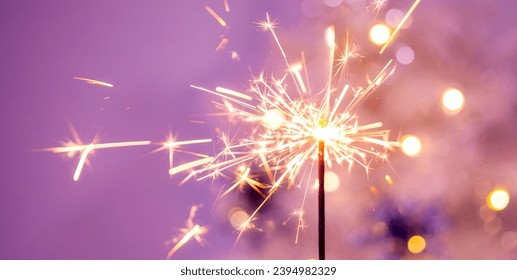 Beautiful sparkles from sparklers on the background of New Year's bokeh, Christmas mood, glitter, festive background. Bright fire on a pink background. - Powered by Shutterstock