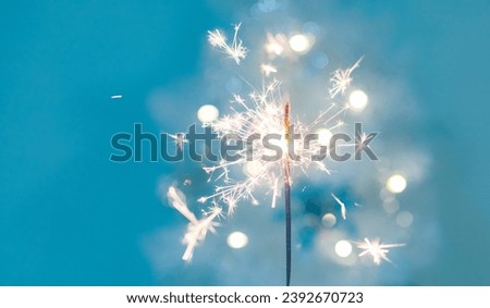 Beautiful sparkles from sparklers on the background of New Year's bokeh,  xmas. Christmas mood, festive background. banner.