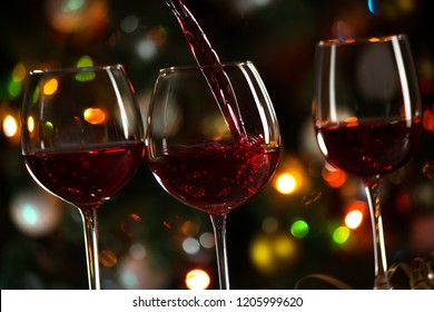 Beautiful Splash Of Red Wine On The Background Of Christmas Lights