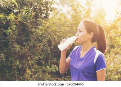 Beautiful Sport Woman Drinking Milk Or Female Athletes Drink Milk After Exercise.