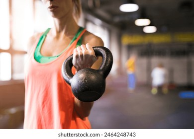 Beautiful sport woman exercising with kettlebell. Routine workout for woman's physical and mental health. - Powered by Shutterstock