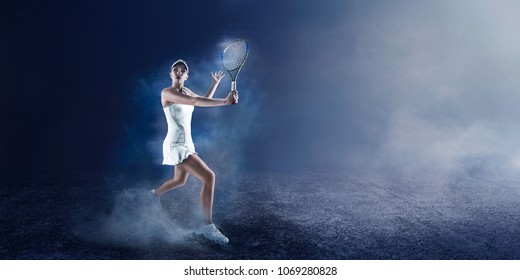 Beautiful sport woman tennis player with racket in white costume on blue background