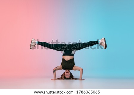 Similar – Man practicing yoga, handstand against a yellow wall