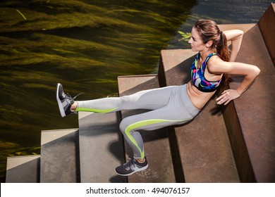 Beautiful sporty caucasian woman doing triceps dips on stairs, healthy lifestyle concept.