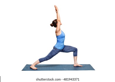 Beautiful sporty fit woman practices Ashtanga Vinyasa Yoga asana Virabhadrasana 1 - warrior pose 1 isolated on white