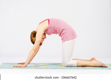 Beautiful Sporty Woman Doing Cat Yoga Pose. Bidalasana.