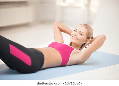 Beautiful Sporty Woman Doing Exercise On The Floor