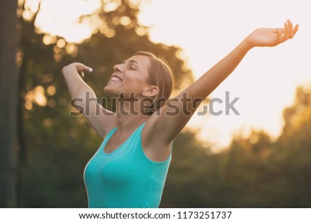 Beautiful sporty woman enjoys with her arms outstretched in the nature.Image is intentionally toned. [[stock_photo]] © 