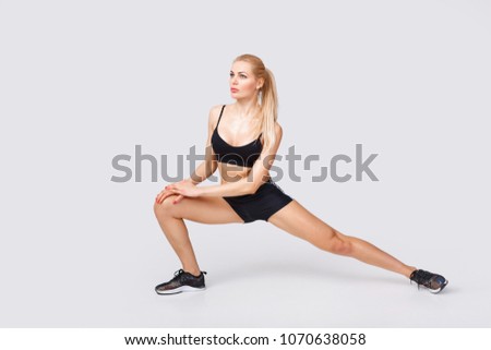 beautiful sporty woman in sportswear does exercises. stretching