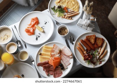Beautiful spring breakfast, morning, eggs. Room service. Breakfast in bed. Freshly squeezed juice, slightly salted salmon