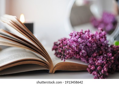 Beautiful Spring Flatlay. Spring Atmosphere At Home With Lilac, Book And Candle