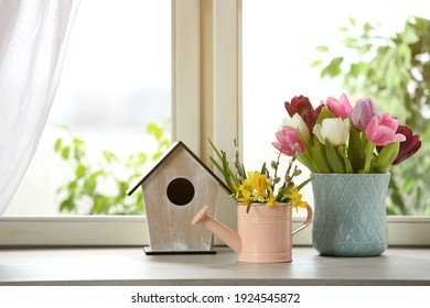Beautiful Spring Flowers With Birdhouse On Window Sill